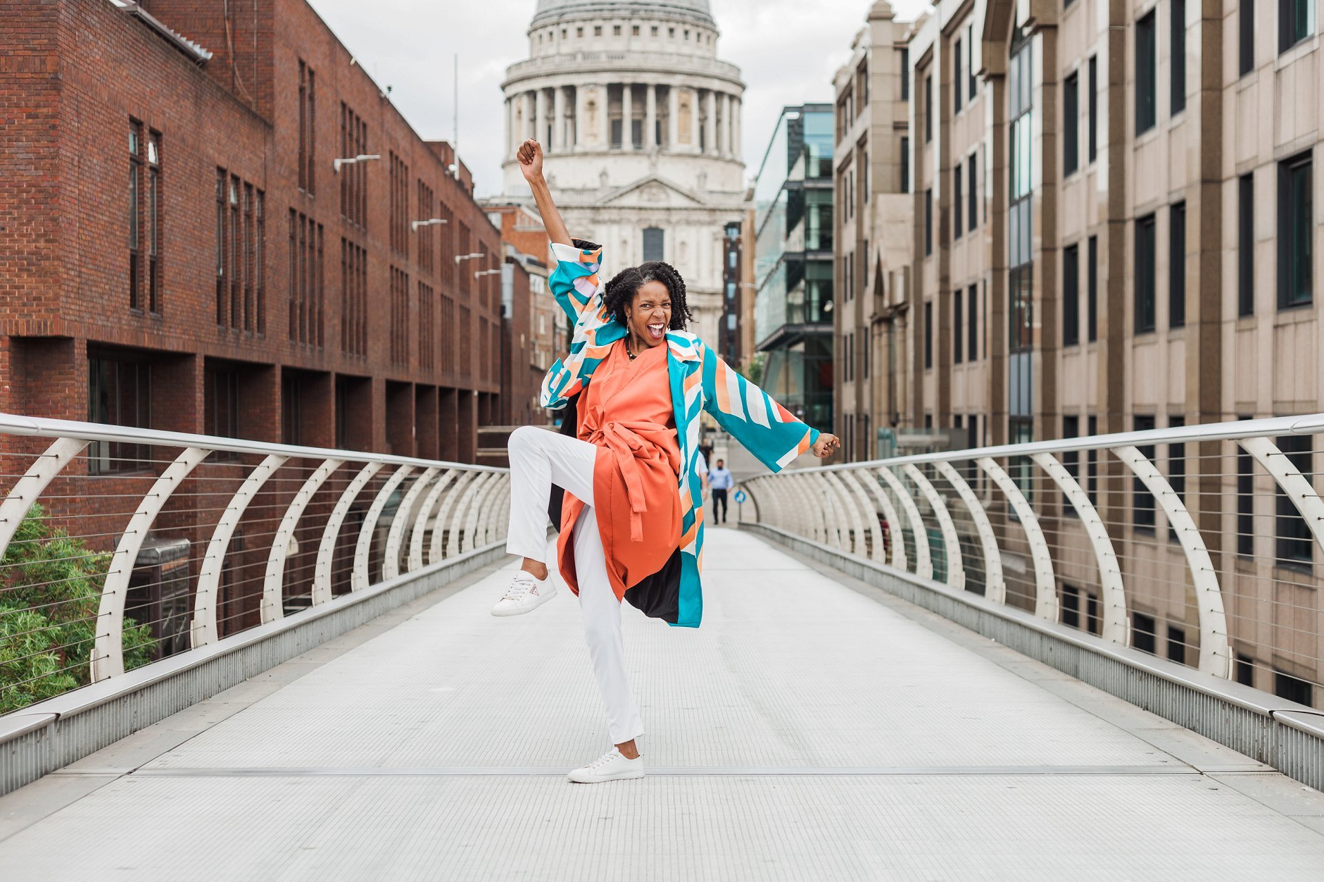 Fashion stylist celebrating on Millennium Bridge for her summer mini brand shoot. Image by London brand photographer AKP Branding Stories