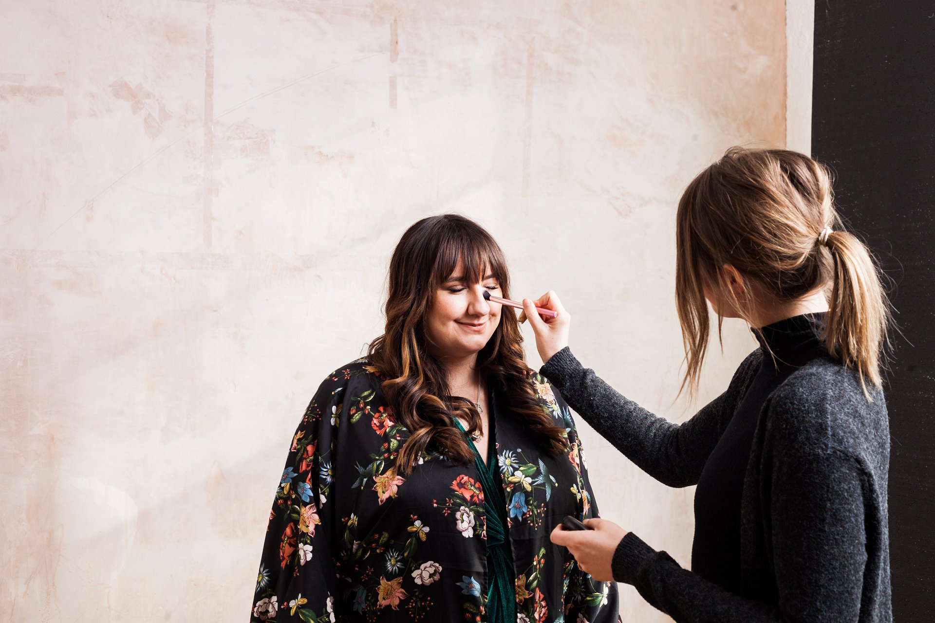 brand shoot hair and makeup artist Pipa working with Nicki James on a shoot. Image by London branding photographer AKP Branding Stories