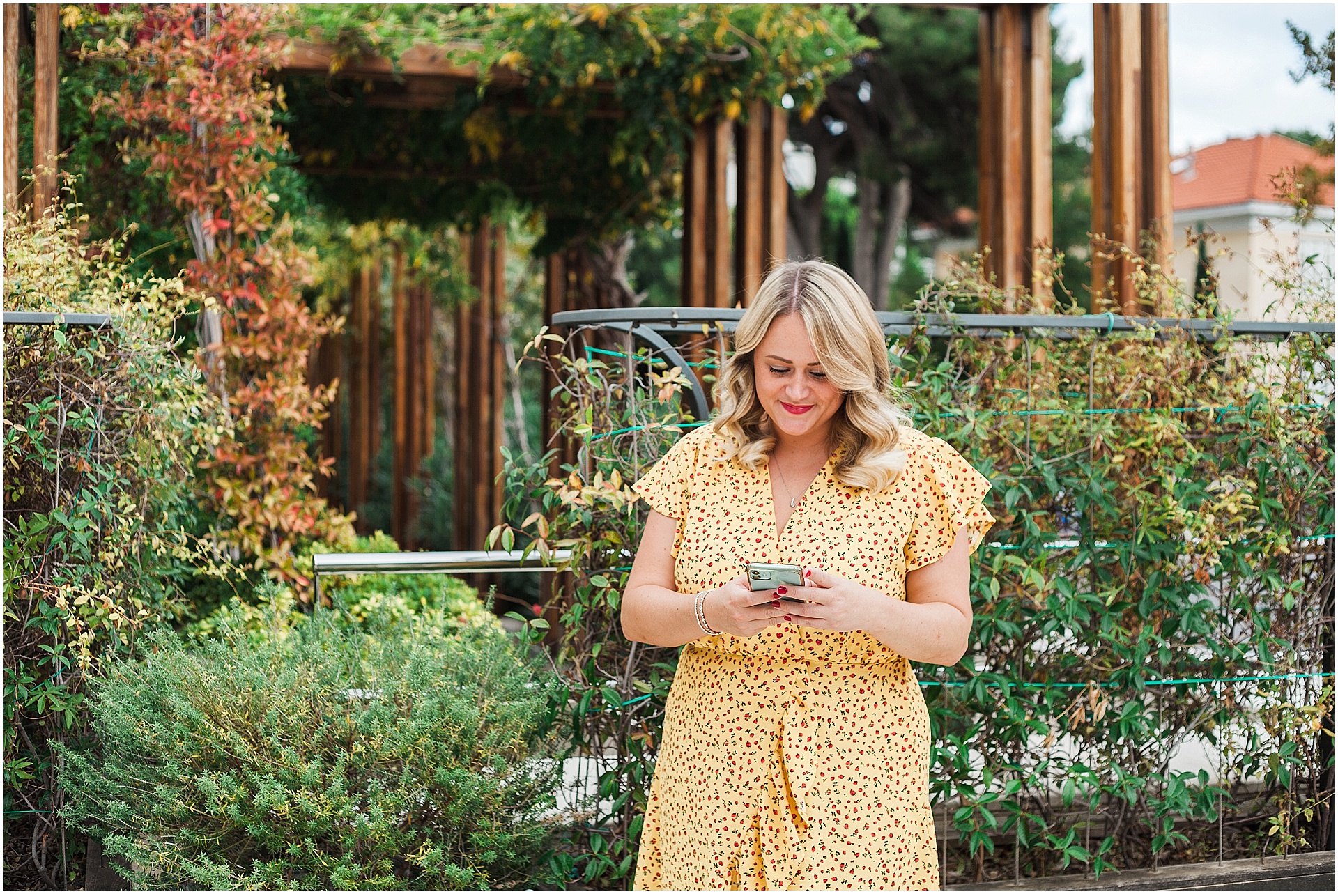 Chantelle on her phone in a garden in Croatia, images by destination brand photographer AKP Branding Stories